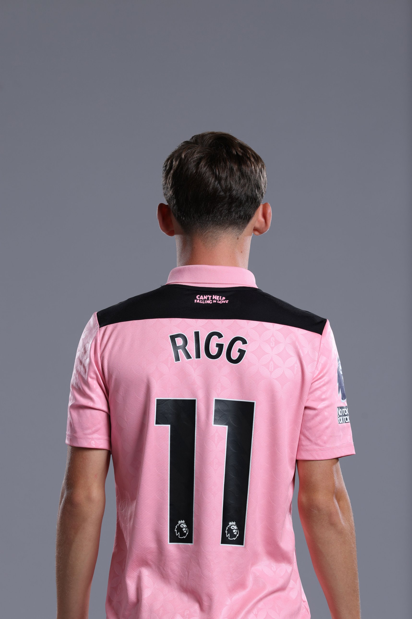 Chris Rigg from behind in the pink kit, name and number 11 on the shirt